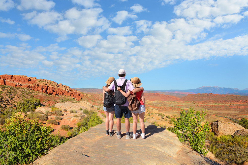 Family standing overlooking scenic view of Utah
